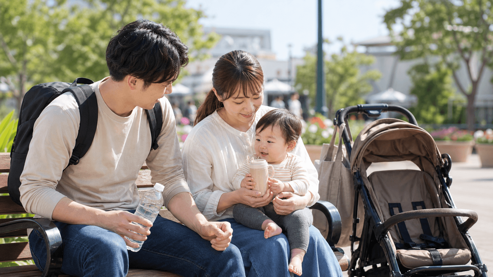 ベンチで赤ちゃん連れの家族が休憩するイメージ