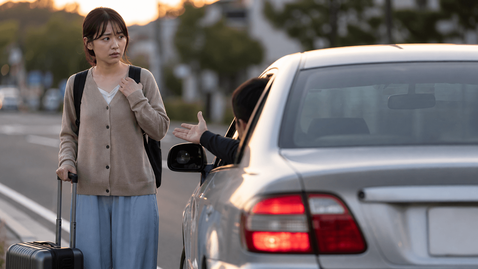 A traveler looking anxious after being led to an unfamiliar car